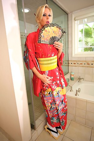 Lovely blonde is looking so sexy wearing Asian uniform. She is masturbating and fucking with her powerful boyfriend in the shower.
